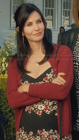 Jules’s black floral dress and red pointelle cardigan on Cougar Town