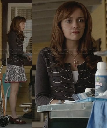 Emma’s black cardigan with white scalloped pattern and floral skirt on Bates Motel