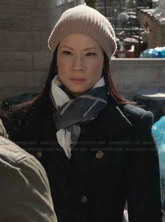 Joan’s green plaid coat and beige ribbed beanie on Elementary