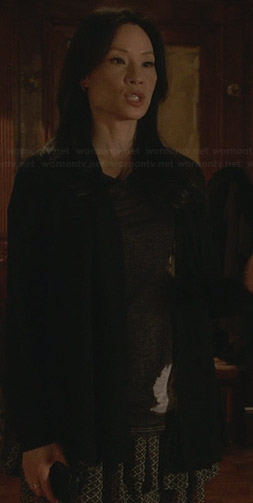Joan’s tiered printed skirt and black tee on Elementary