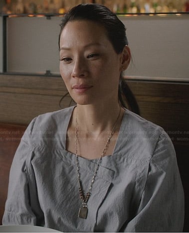 Joan’s light grey wide sleeve dress on Elementary