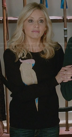 Sydney’s black bird sweater and pink and red earrings on The Crazy Ones