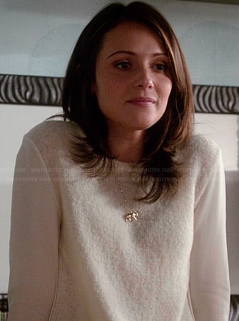 April’s white sweater with sheer sleeves and gold elephant necklace on Chasing Life