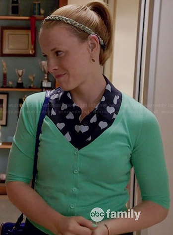 Daphne’s navy heart print shirt and green v-neck cardigan on Switched at Birth