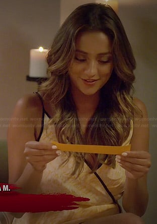 Shay Mitchell’s orange wrap dress with black trim on Pretty Little Liars