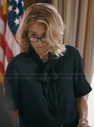 Elizabeth’s black short sleeved neck tie blouse on Madam Secretary