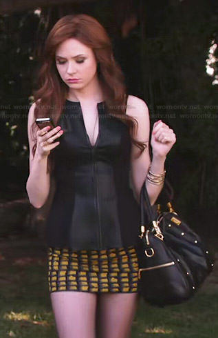Eliza’s black leather split-neck top and yellow printed mini skirt on Selfie