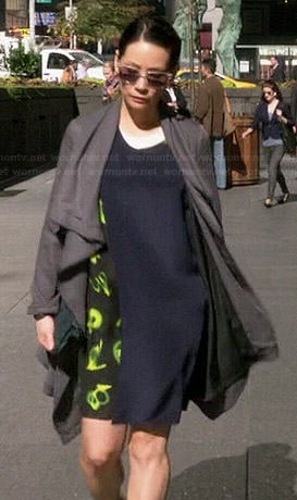 Joan’s green printed layered dress and grey coat on Elementary