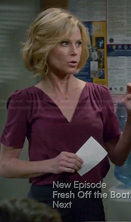 Claire’s purple split neck blouse on Modern Family