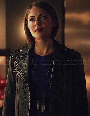 Thea’s blue and black patterned dress and leather jacket on Arrow