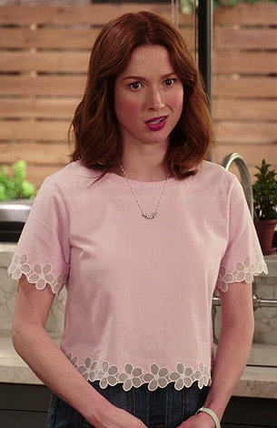 Kimmy’s pink top with flower trim on Unbreakable Kimmy Schmidt