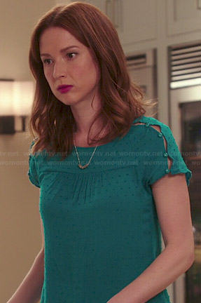 Kimmy’s teal green button shoulder top on Unbreakable Kimmy Schmidt