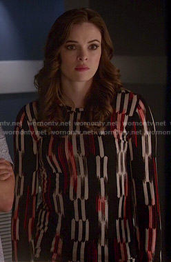 Caitlin’s black, white and red printed long sleeve top on The Flash