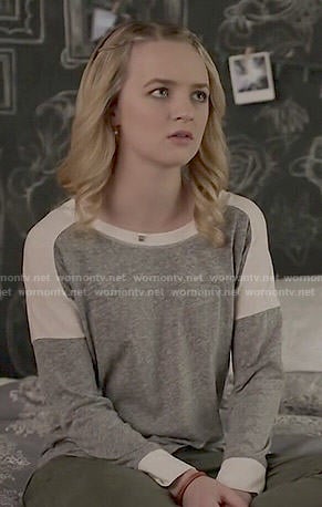 Taylor’s grey and white long sleeved tee on Finding Carter