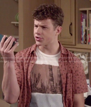 Luke’s cactus graphic tee and orange printed shirt on Modern Family