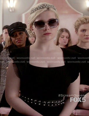 Chanel 5’s black dress with ruffled sleeves on Scream Queens