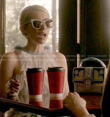 Chanel’s feather dress and patterned bag on Scream Queens