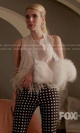 Chanel’s checked trousers and feather trim top on Scream Queens