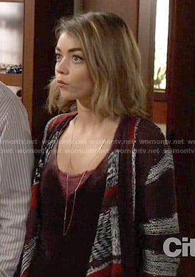 Haley’s burgundy velvet top and striped oversized cardigan on Modern Family