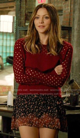 Paige’s red perforated sweater and printed skirt on Scorpion