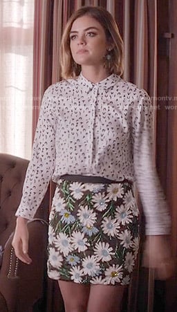 Aria’s white symbol print shirt and floral sequin skirt on Pretty Little Liars
