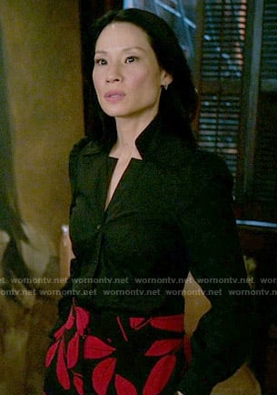 Joan’s black and red leaf print trousers on Elementary