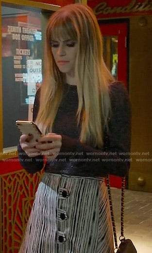 Brooke’s metallic sweater and striped button front skirt on Scream