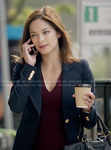 Cat’s navy blazer with gold buttons on Beauty and the Beast