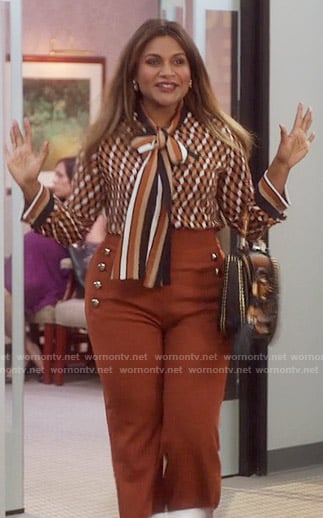 Mindy’s brown front button trousers and printed tie neck blouse on The Mindy Project