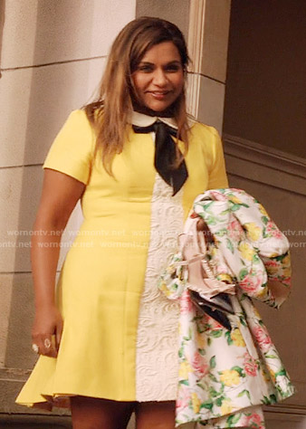 Mindy’s yellow dress with white lace panel and tie neck and floral coat on The Mindy Project