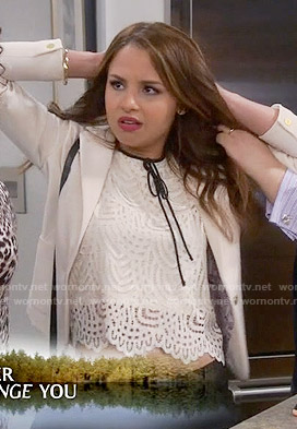Sofia’s white lace top with black tie neck on Young and Hungry
