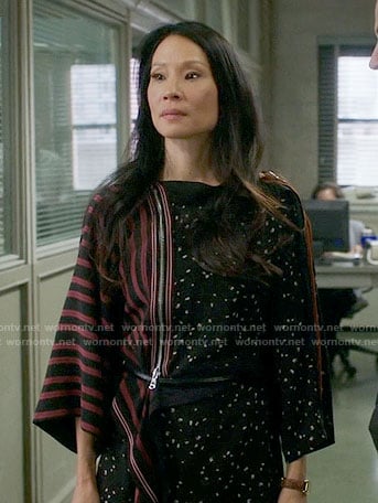 Joan’s black dotted print dress with striped sleeve on Elementary