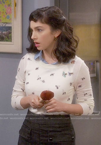Mandy’s bee print sweater and black skirt with front pockets on Last Man Standing