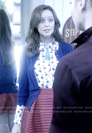 Cassandra’s palm tree print shirt and red pleated skirt on The Librarians