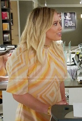 Kelsey’s orange diamond print dress and gold choker on Younger
