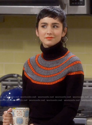 Mandy’s black turtleneck sweater with orange stripes on Last Man Standing