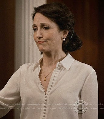 Nadine’s white buttoned blouse on Madam Secretary