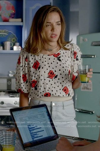 Cassandra’s rose print top and studded denim skirt on Famous in Love