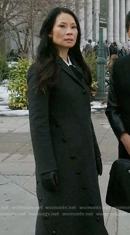 Joan’s long black coat with asymmetrical buttons on Elementary