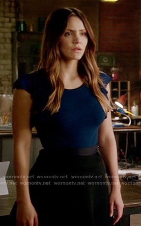 Paige’s navy flutter sleeve top and black skirt on Scorpion
