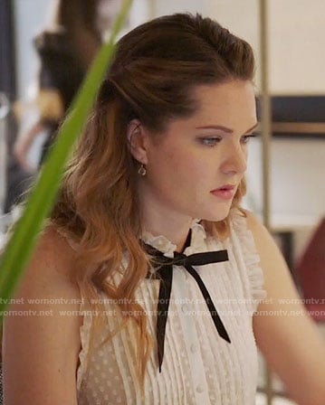Sutton’s white dotted top with black tie neck on The Bold Type