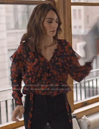 Sam’s black and red floral ruffled blouse on Friends from College
