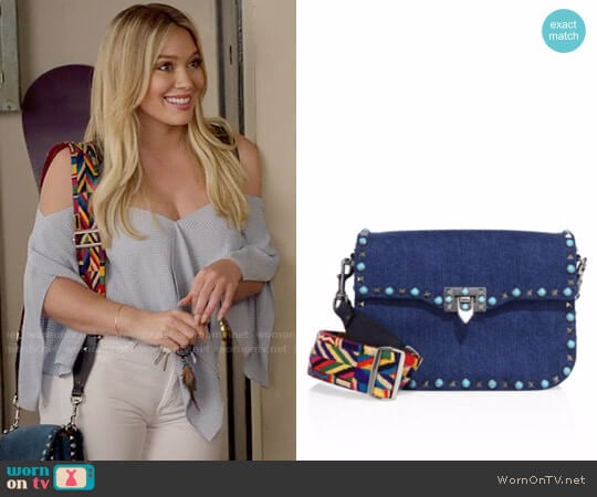 Valentino Rockstud Rolling Denim Guitar-Strap Shoulder Bag worn by Kelsey Peters (Hilary Duff) on Younger