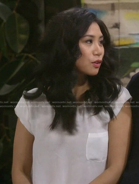 Eve’s white front pocket short sleeve top on 9JKL
