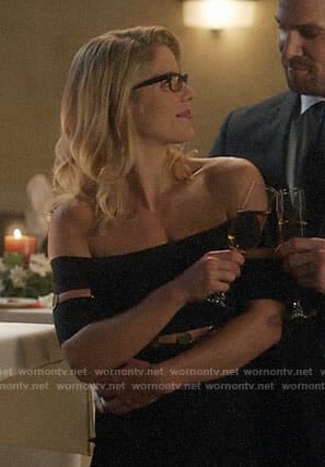 Felicity’s black off-shoulder dress with metal discs on Supergirl