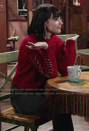 Tessa’s red sweater with rings on The Young and the Restless