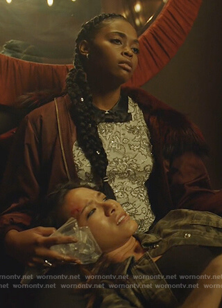 Anissa’s burgundy fur trim bomber jacket and white lace top on Black Lightning