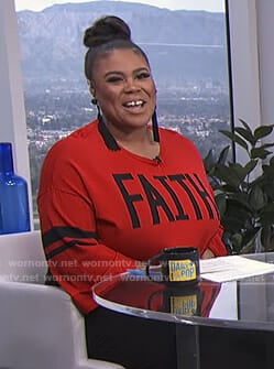 Nina’s red faith sweater on E! News Daily Pop