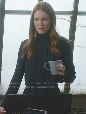 Abby’s navy tie neck blouse on Scandal