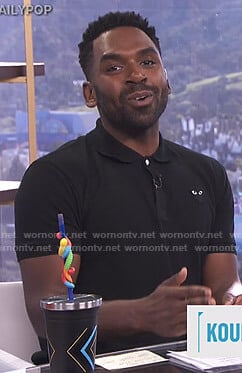 Justin’s black polo shirt with heart patch on E! News Daily Pop